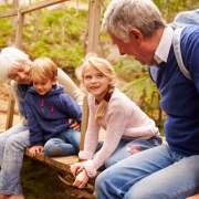 Sm grandparents sitting on bridge with grandkids copy