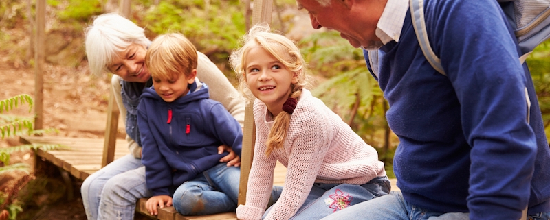 Sm grandparents sitting on bridge with grandkids copy